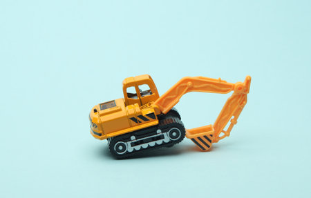 Toy excavator on blue background