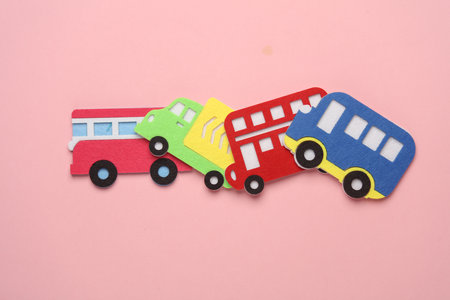 Toy buses and Truck made of felt on pink background.の写真素材