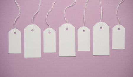 Set of blank white tags with ropes on magenta background. Mock up, Template for design. Sale,...