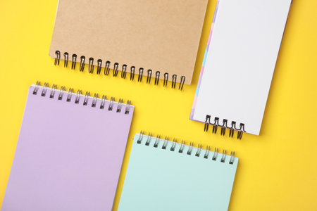 Different notepads on a yellow background