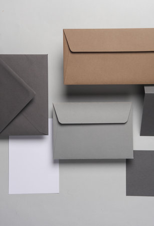 Floating envelopes and cards on gray background with shadow. Minimalism, modern business still life,...