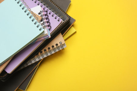 Stack of notepads on yellow background