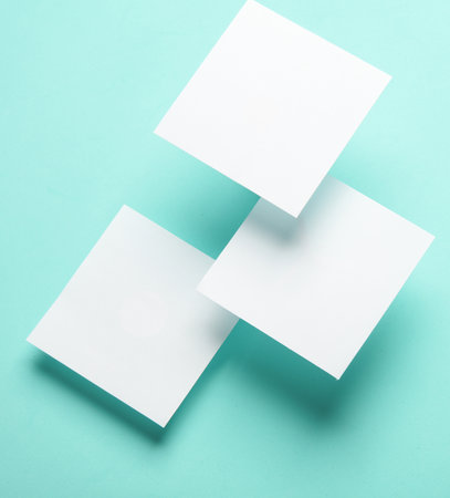 Composition of floating white square memo papers on blue background. Business conceptの写真素材