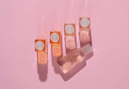 Antiseptic bottles on a pink background with shadow