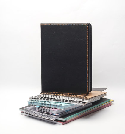 Stack of different notepads on white backgroundの写真素材