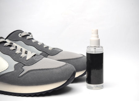 Sneakers and water protection spray on white background. Shoe careの写真素材