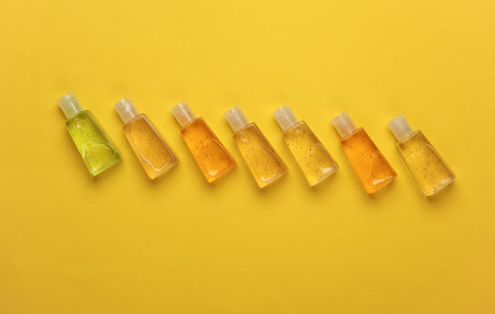 Antiseptic bottles on yellow background. Top viewの写真素材
