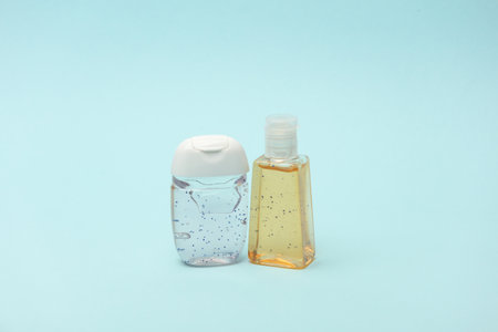 Antiseptic bottles on blue background close up.の写真素材
