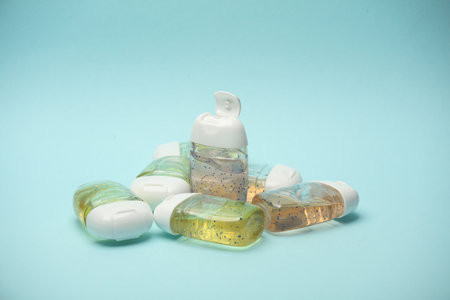 Antiseptic bottles on blue background close up.の写真素材