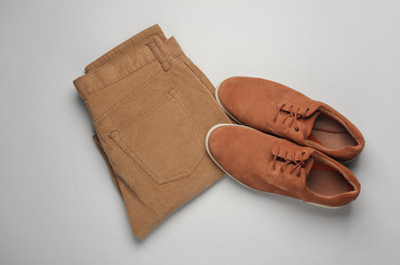 Trousers and suede shoes on gray background. Creative fashion layout. Men's style. Top viewの写真素材