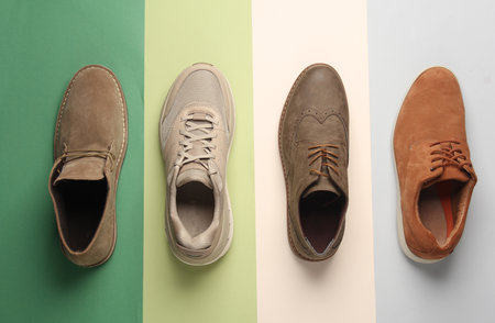 Different men's shoes on a colored background. Top view. Creative fashion layoutの写真素材