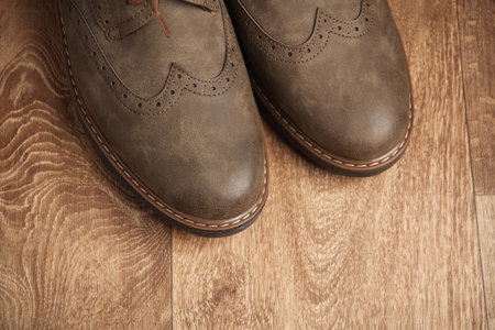 Leather men's brogue shoes on wooden floorの写真素材