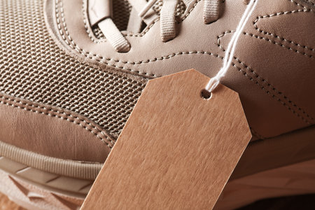 Sports sneakers with a tag on a string. Sale, fashion concept