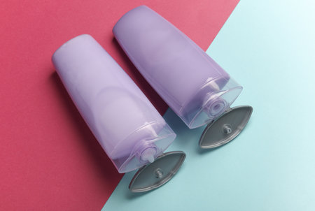 Shampoo bottles on blue pink background