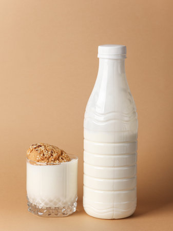 Yogurt bottle and cereal cookies on brown background. Healthy foodの写真素材