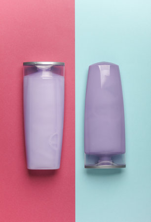 Shampoo bottles on blue pink background