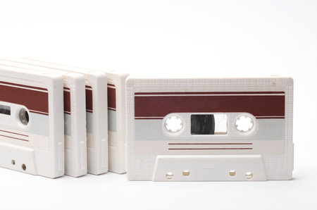 Stack of retro 80s audio cassettes on white background