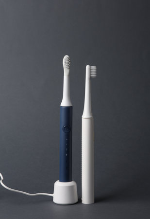 Modern smart ultrasonic toothbrushes on dark gray backgroundの写真素材