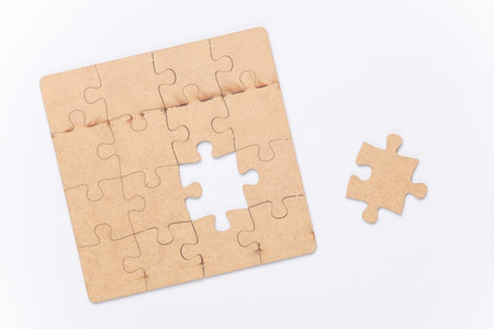 Wooden pieces jigsaw puzzle on white backgroundの写真素材