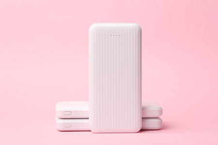 White power banks on pink background. External battery