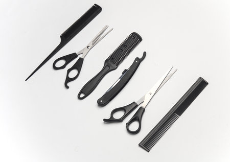 Hair cutting scissors and straight razor, cjmbs on a white background. Barber's working toolsの写真素材