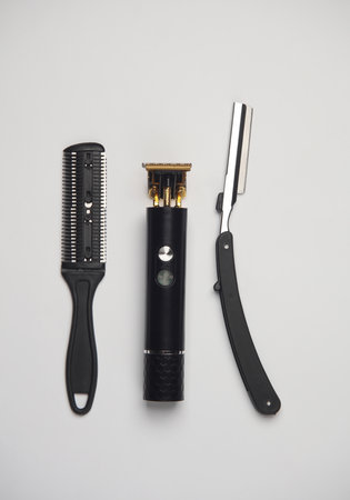 Hair comb, trimmer and straight razor on a white background. Barber tools