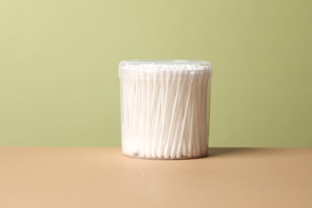 Ear sticks in a transparent box on a beige green background