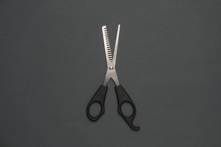 haircutting scissors on dark gray backgroundの写真素材
