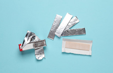 Chewing gum in foil on a blue backgroundの写真素材