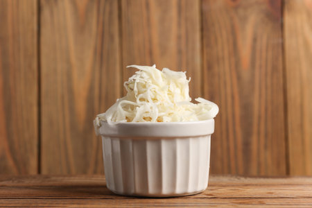 Sauerkraut in a ceramic bowl on a wooden background
