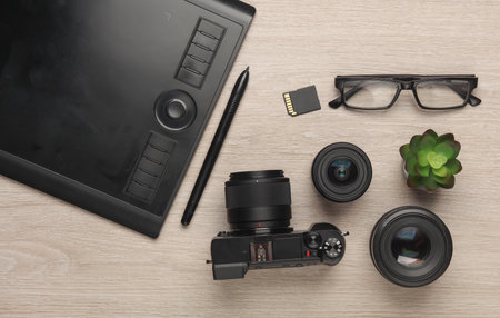 Camera and photographic accessories on the table. Top view