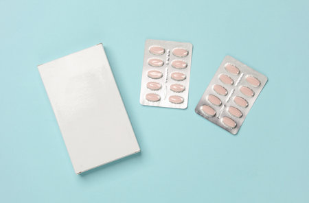 Box of pills on blue background