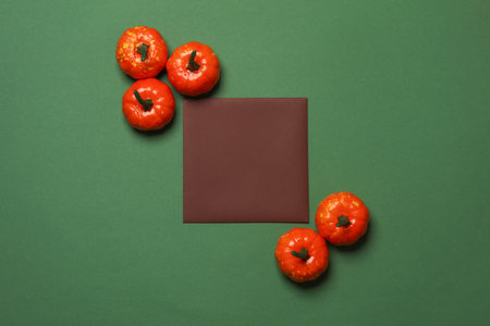 Square invitation card with Halloween decor on green background