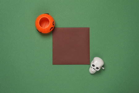 Square invitation card with Halloween decor on green backgroundの写真素材