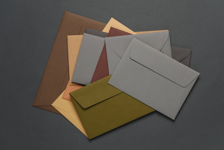 Stack of colored envelopes on dark gray background