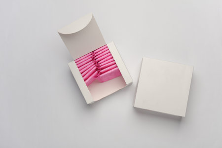 Box with sanitary pads on gray background. Feminine hygieneの写真素材