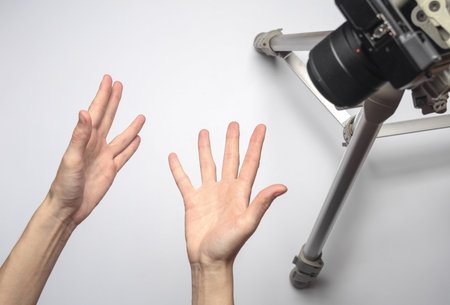 Emotional hands hang on the camera. Blogging, vloggingの写真素材