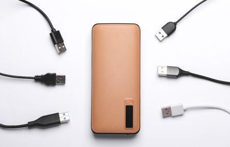 External battery power bank with many cables on a white background