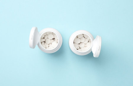 Pills in plastic bottles on a blue background. Medicine concept. Top view