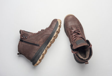 Pair of Brown leather boots on white background