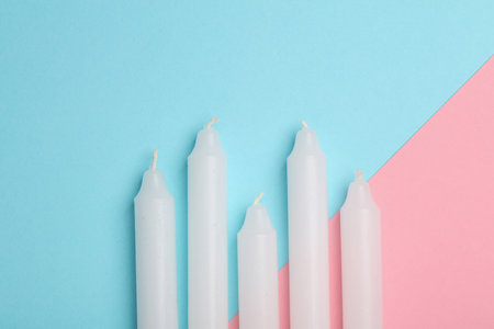Set of wax candles on a blue pink backgroundの写真素材