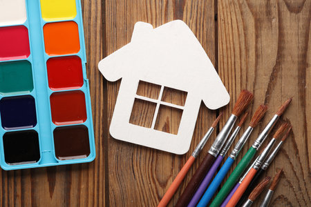 White wooden house blank and paint with brushes on the tableの写真素材