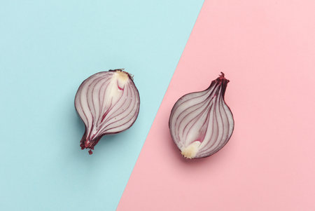 Red onion on a blue pink background. Top viewの写真素材