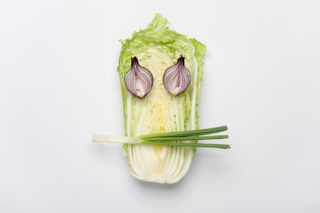 Vegetables in the shape of a face on a white background. Minimalism concept. Healthy eating, veganの写真素材