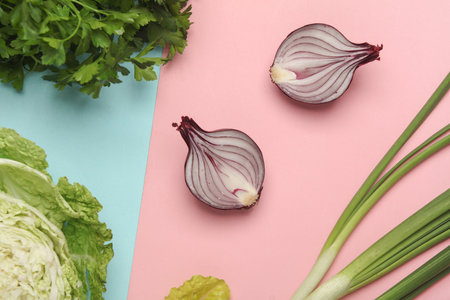 Fresh greenery, vegetables on a pink blue background. Healthy food, vegetarianism. Flat layの写真素材