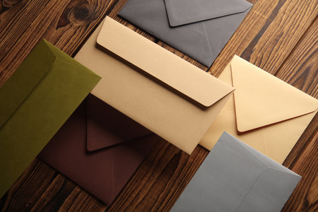 Creative layout of floating colored envelopes on wooden boardsの写真素材