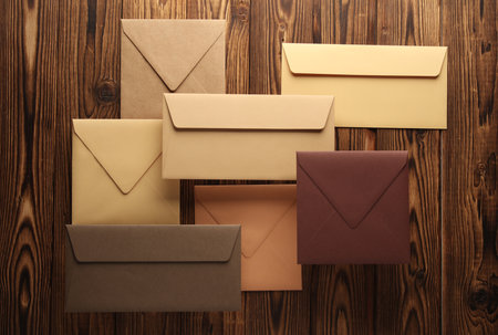 Creative layout of floating colored envelopes on wooden boardsの写真素材