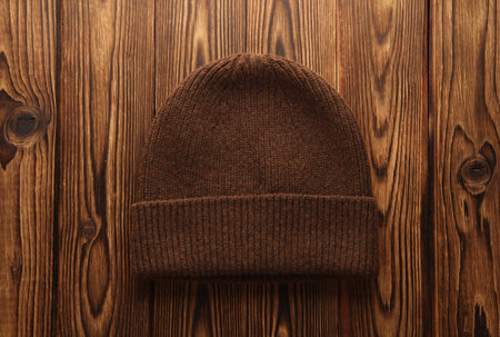 Warm winter hat on wooden background. Top viewの写真素材