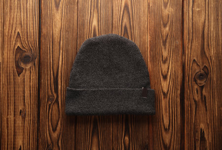 Warm winter hat on wooden background. Top viewの写真素材