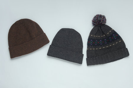 Woolen warm winter hats on white background. Top viewの写真素材